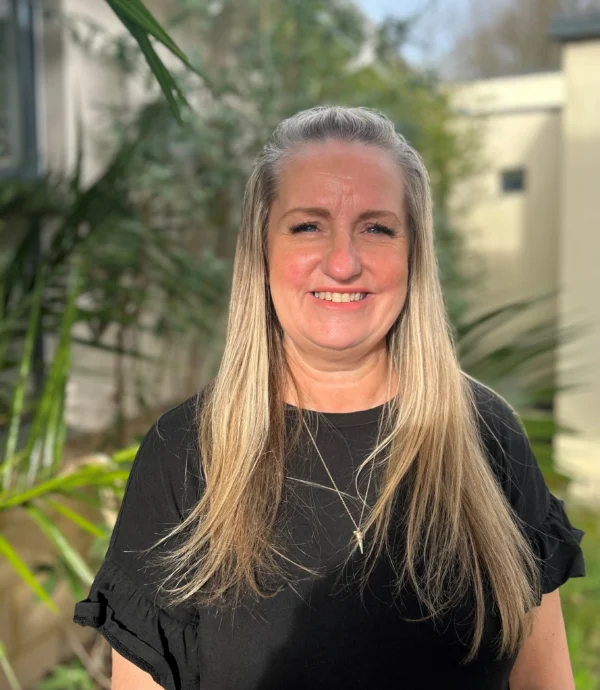 Portrait of Michele Haigh, Cornwall Saracens Basketball Club Welfare Officer, smiling outdoors in natural light.